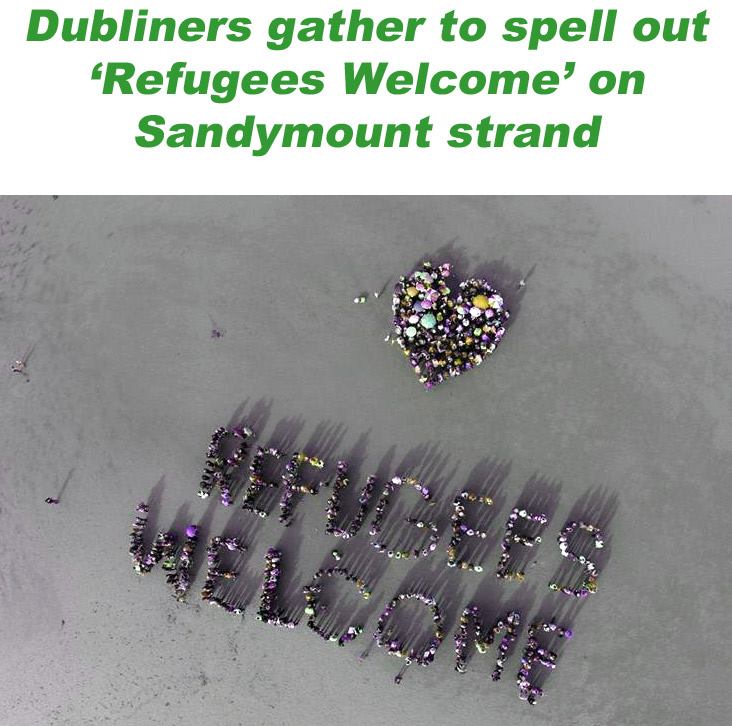 Crowd spells out Refugees Welcome on Sandymount strand in Dublin - Drone photo